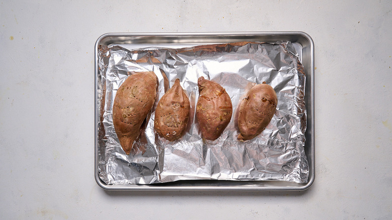 baked sweet potatoes on sheet tray