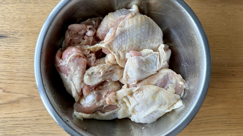 raw chicken in metal bowl