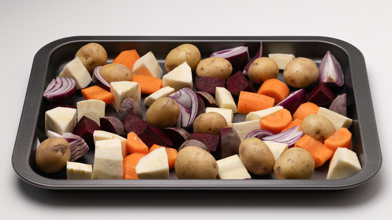 uncooked root vegetables on sheet pan