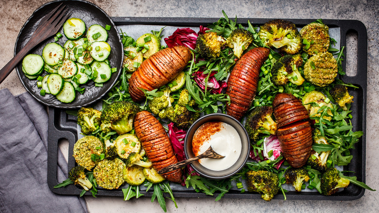 sheet pan salad with roasted potatoes, broccoli, squash, and arugula