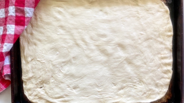 dough spread on baking sheet