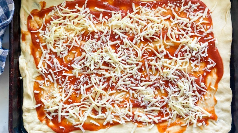 dough with tomato sauce and cheese