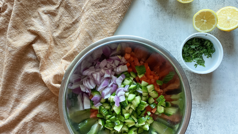 tomatoes, cucumbers, onion in bowl