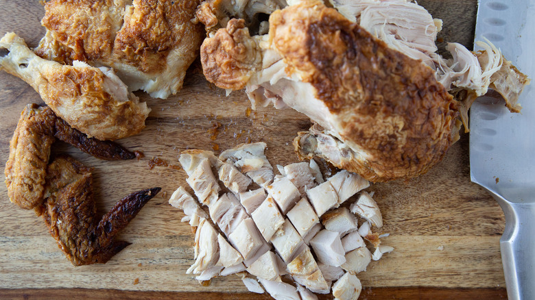 rotisserie chicken on cutting board 