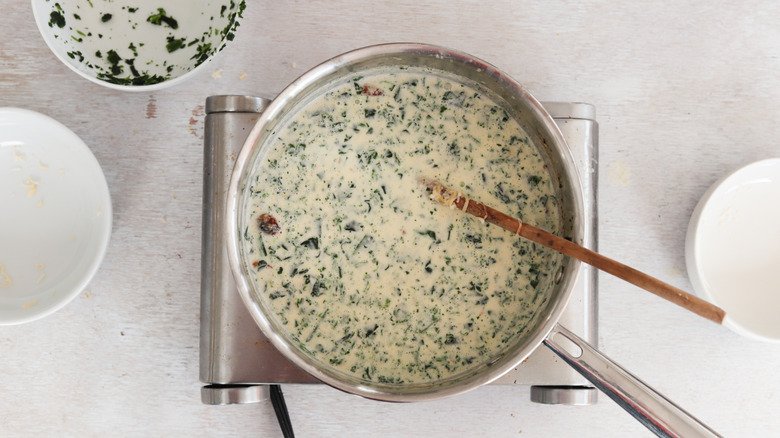 spinach cream sauce in saucepan