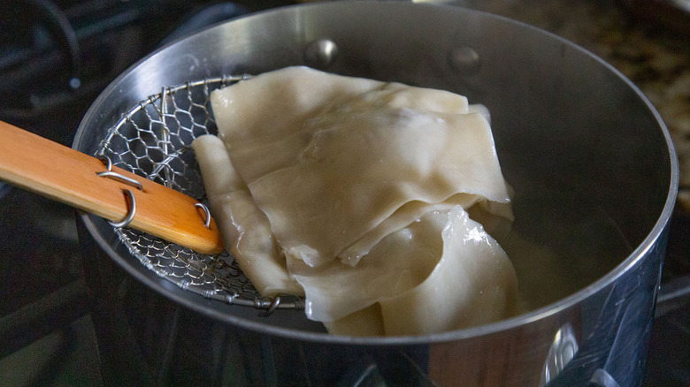cooked ravioli and large pot