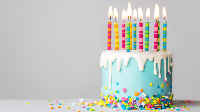 light blue birthday cake with candles