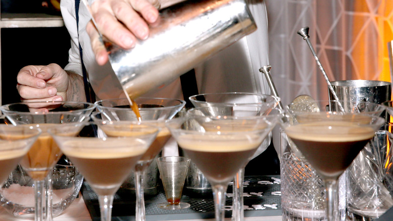 bartender pouring chocolate cocktails from shaker