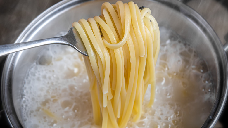 cooked pasta over boiling water