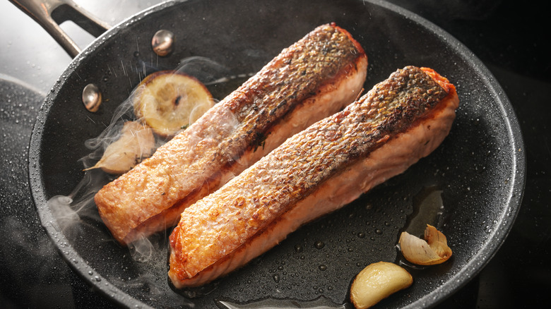 Two salmon filets in a pan, skin side up