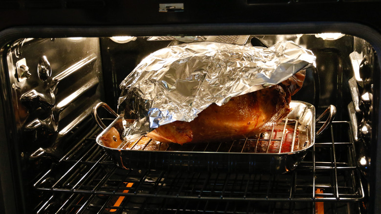 covered turkey in oven