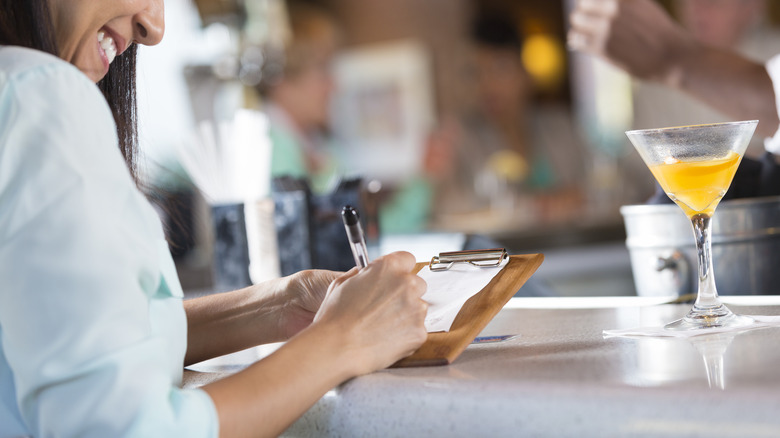 Diner leaving a tip for a server