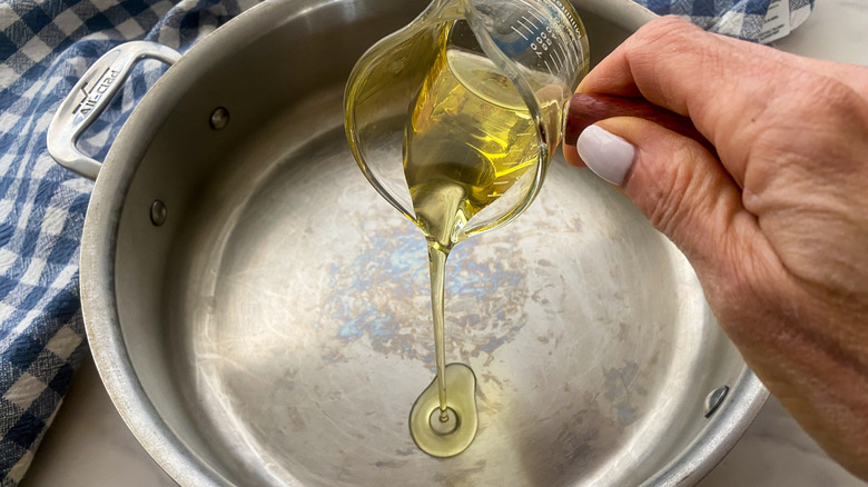 adding oil to pan