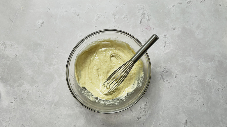 whisking dressing in bowl