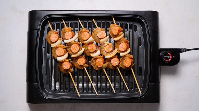 cooking skewers on grill