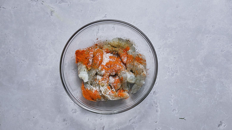 shrimp and seasonings in glass bowl