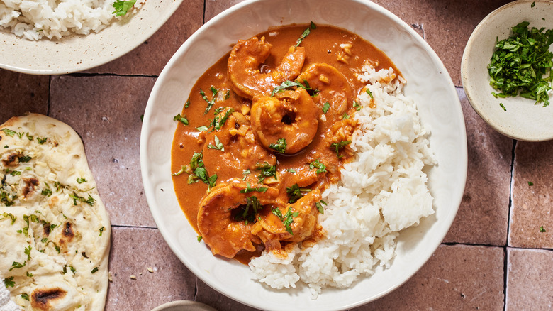 cilantro on top of shrimp curry with white rice