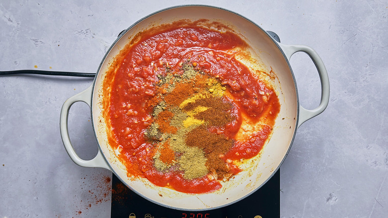 seasonings in tomato sauce in skillet