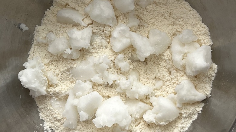 close-up of coconut oil in dry pie crust ingredients