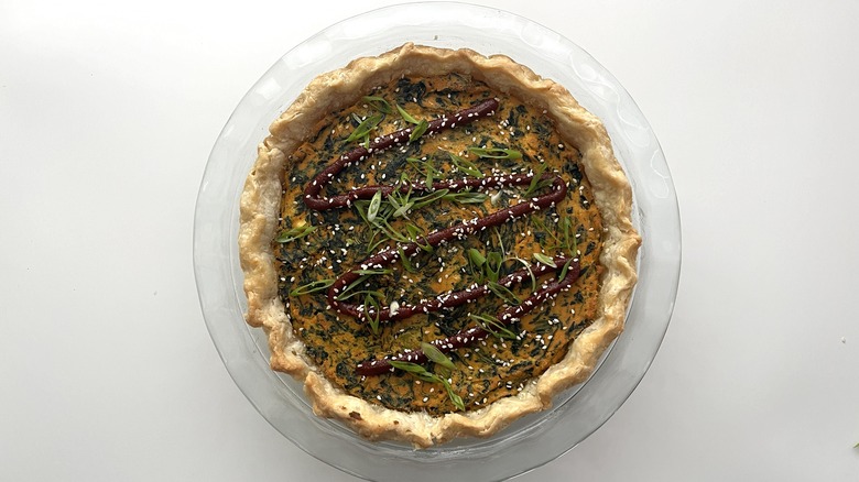 Sigeumchi Namul-Inspired Vegan Quiche garnished with gochujang, scallions, and sesame seeds