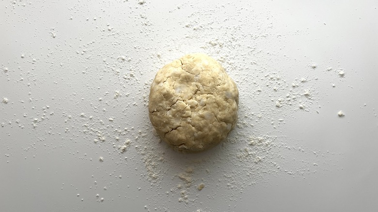 disc of dough on a floured surface
