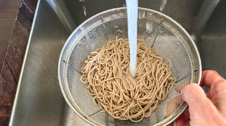 strainer under water rinsing noodles