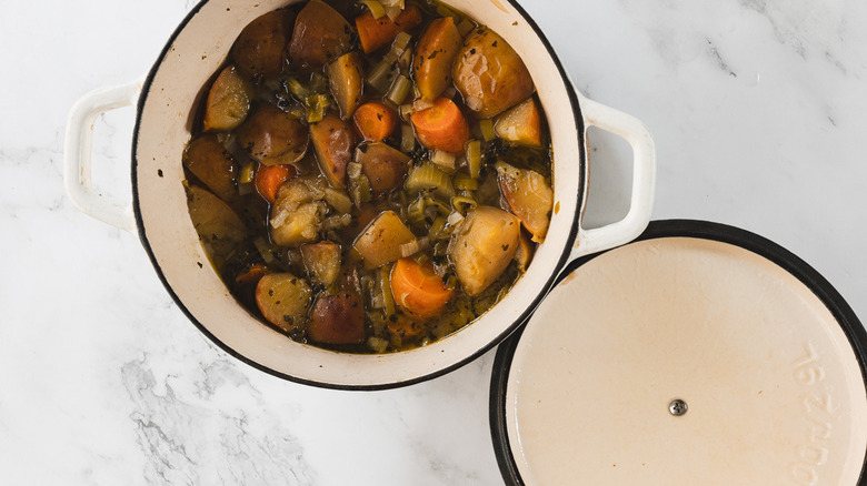 Open pot of soup with lid