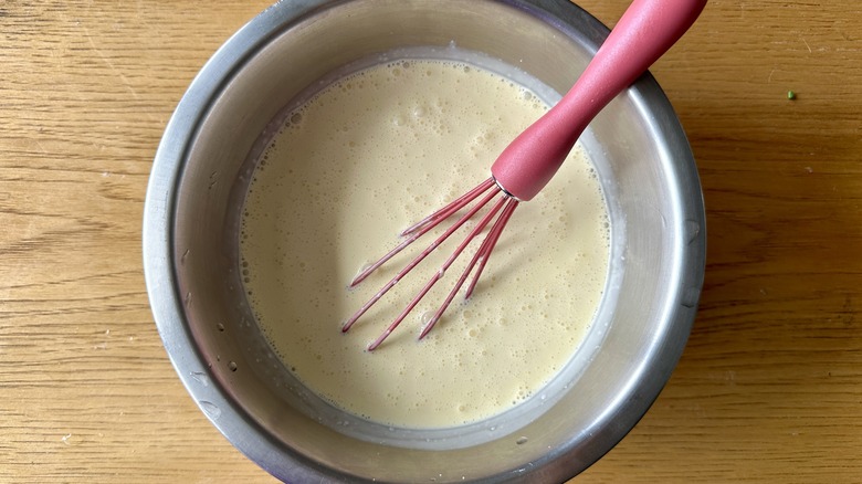 Whisking cream into yolks