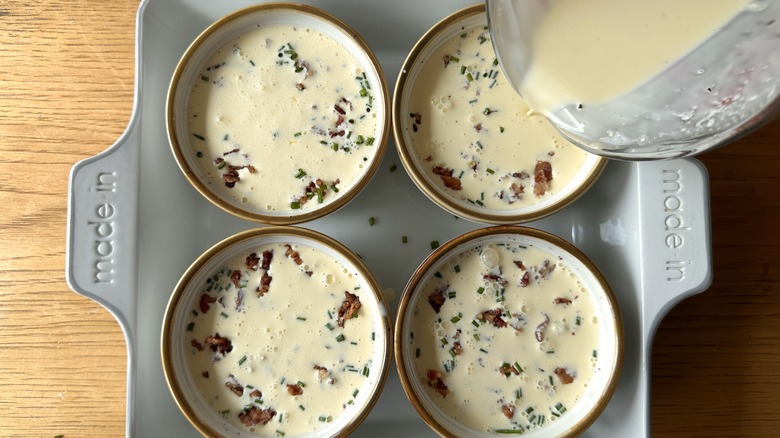 Pouring custard into ramekins