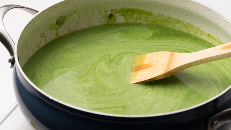 Mixing cream of spinach soup