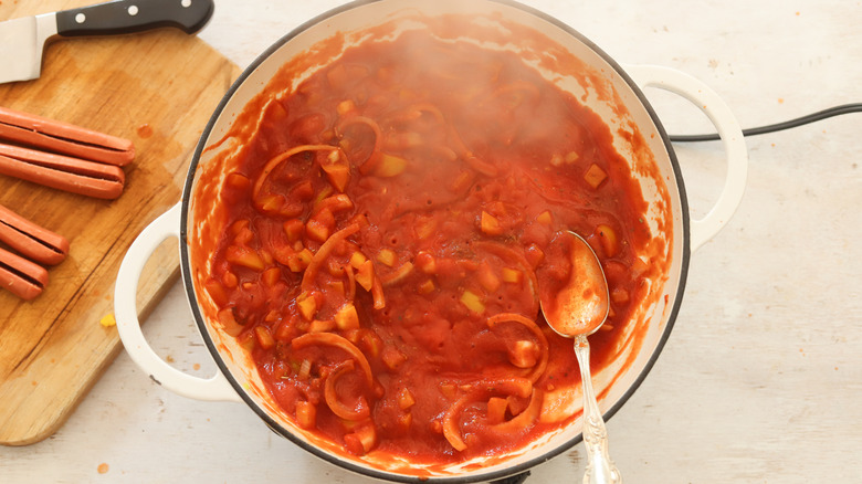 tomato sauce and onion in pan