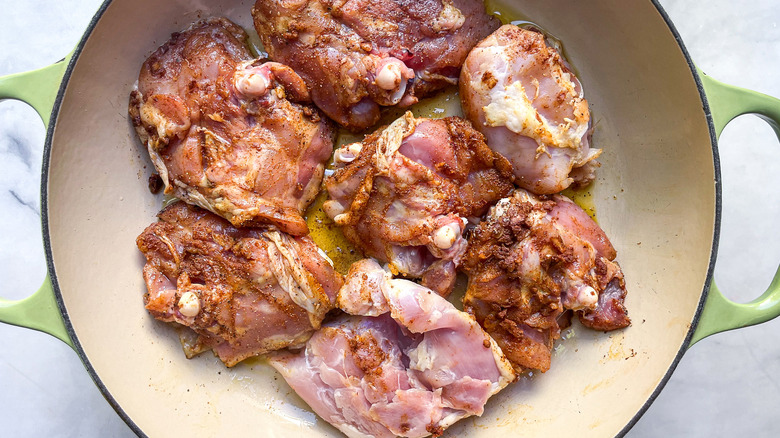 raw chicken thighs in pan