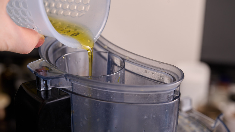 pouring oil into food processor