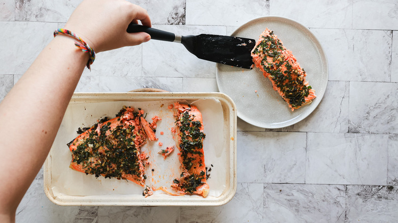 Transferring salmon onto plate