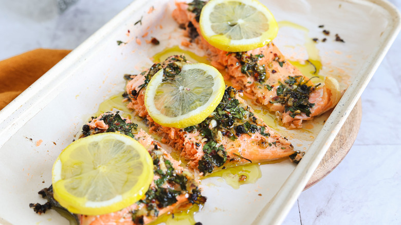 Three salmon filets on baking sheet