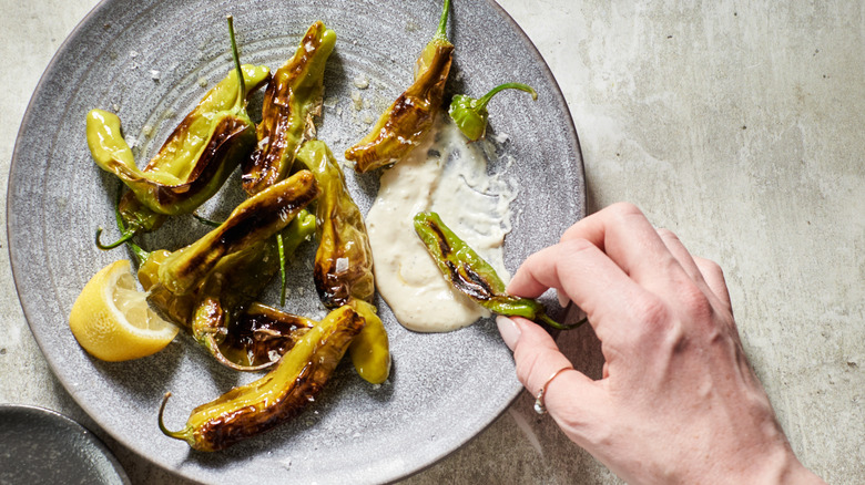 dipping pepper into aioli