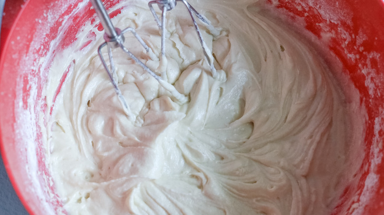 beating together blueberry bread batter