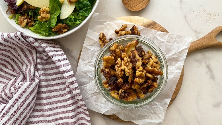 candied walnuts in glass jar on parchment paper