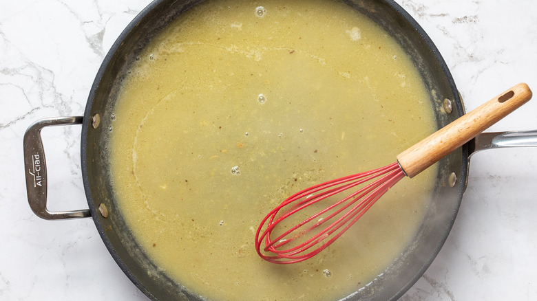 whisking lemon butter wine sauce