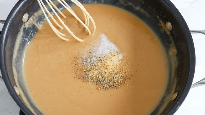 gravy with seasonings in saucepan