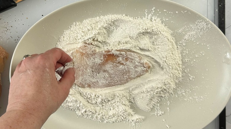 chicken dredged in flour on plate