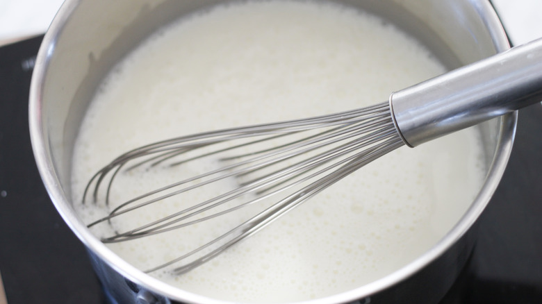 whisking pudding mixture in pot