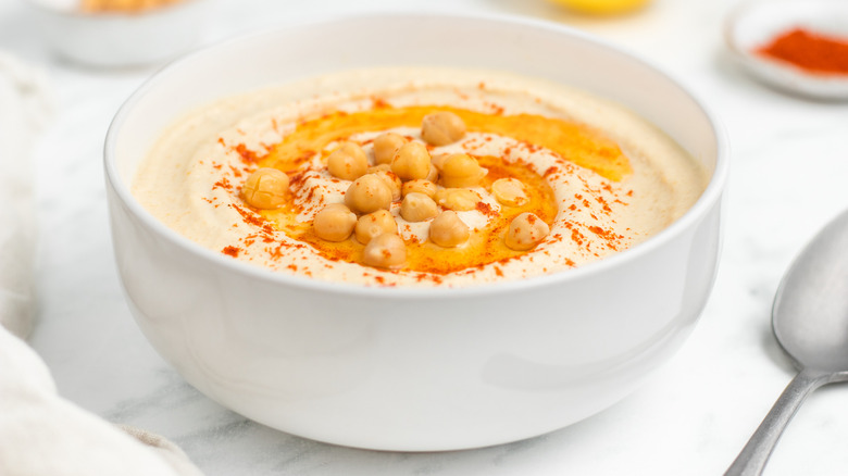 hummus in bowl with garnishes