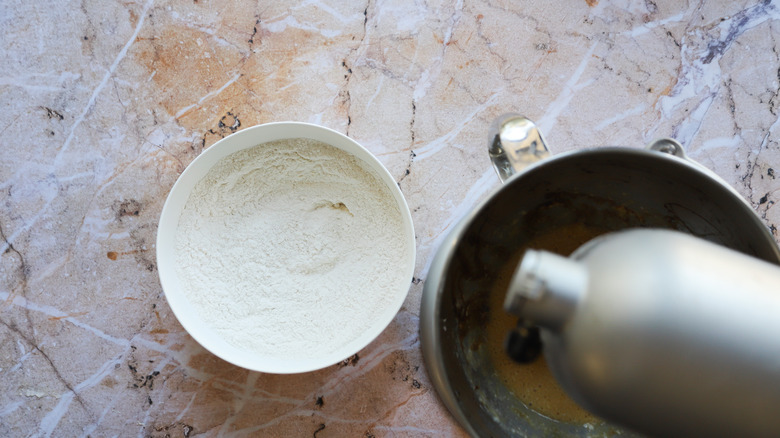 Adding flour mixture to bowl