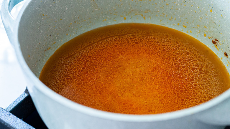 rice and broth in skillet