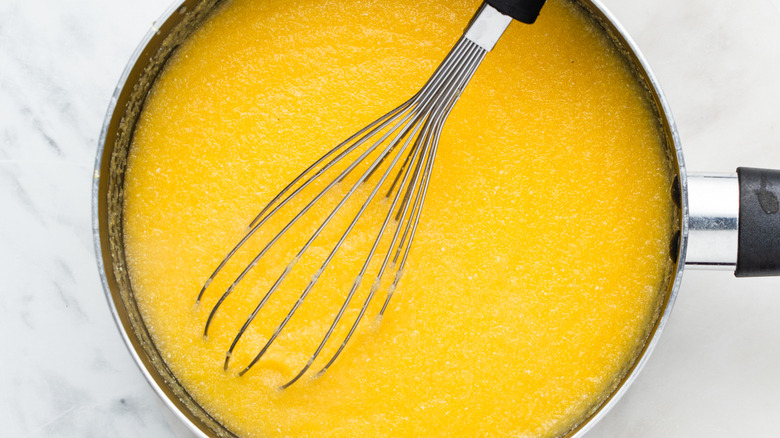 whisk sitting in polenta