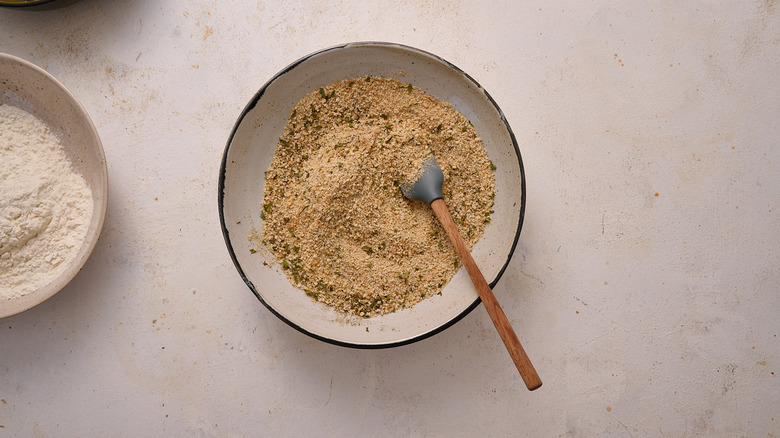 mixing breadcrumbs with seasonings