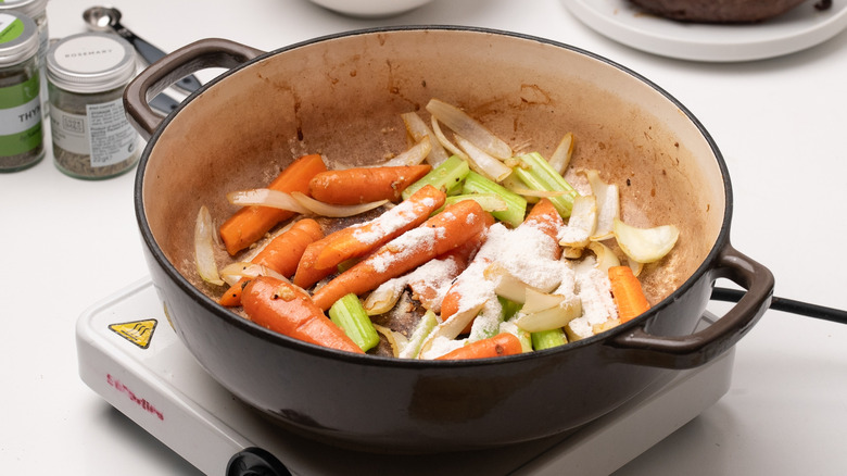 Vegetables and flour in pan