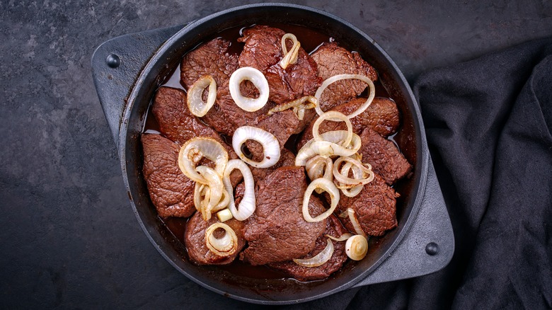 browned onion rings over steak