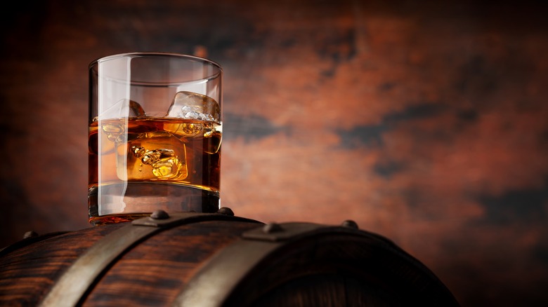 Bourbon on the rocks on a barrel